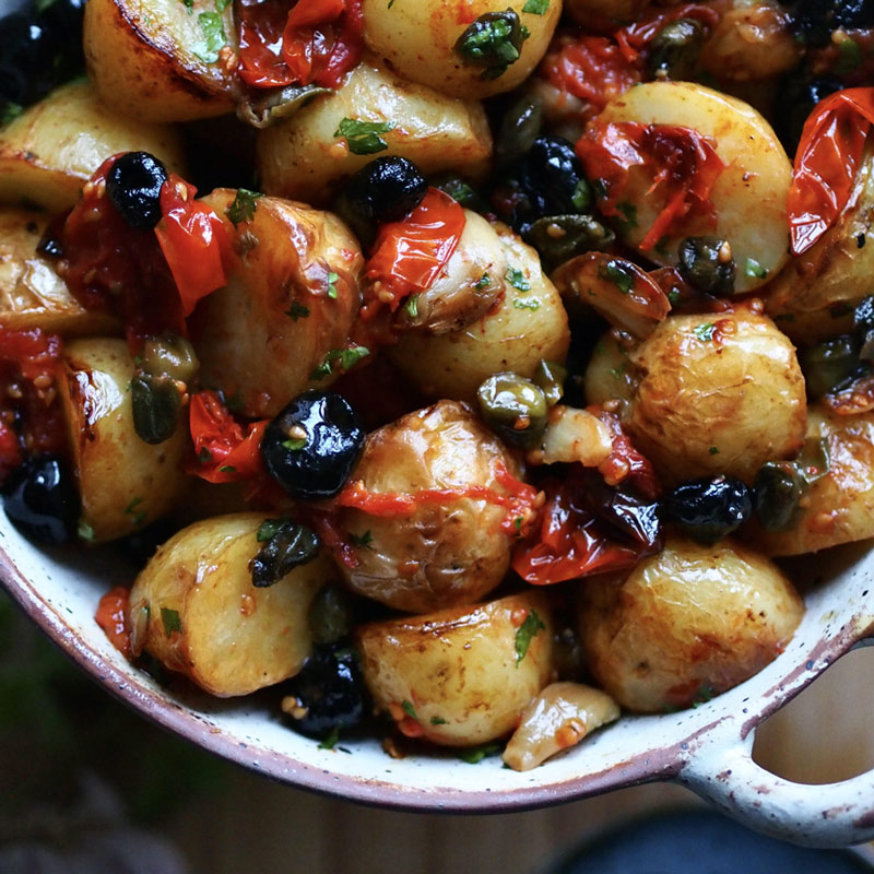 Baby baked potatoes with olives, capers & tomatoes