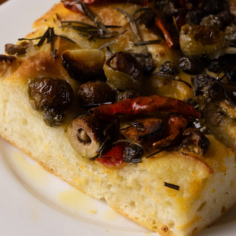 Focaccia with olives, capers and piri piri peppers